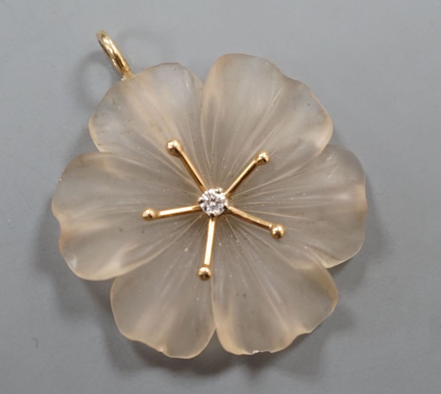A yellow metal and diamond set frosted glass petal pendant, overall 33mm.